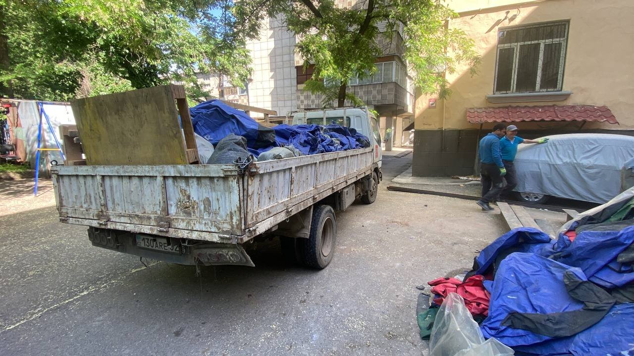 Грузим мешки во двор в кузов нашего грузовика в Алматы